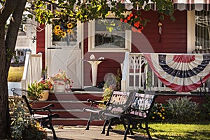 The veranda of a American house is decorated with US decorations.