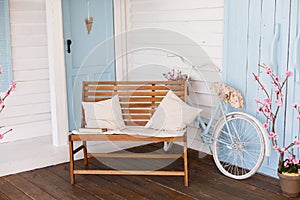 Veranda country house, bench and bicycle.