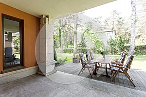 Veranda with wooden table and chairs