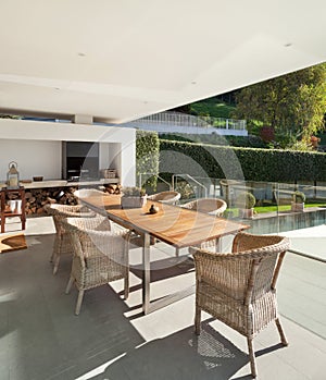 Veranda, wooden table and wicker chairs