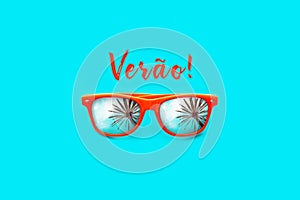 Verao text in Portuguese: Summer and orange sunglasses with palm tree reflections isolated in large cyan background