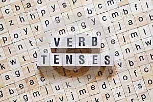 Verb tenses word concept on cubes photo