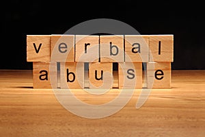 Verbal abuse words written on wood cube photo