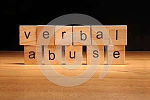 Verbal abuse words written on wood cube