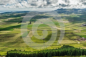 Verdant landscape in caldera of old volcano with pastures and views of the Atlantic Ocean in Serra do Cume, Terceira - Azores