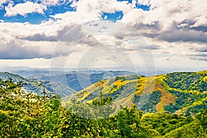 Verdant slopes of Monteverde under a dynamic sky, showcasing the rich biodiversity and layered mountain vistas of