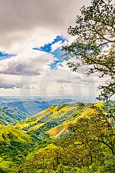 Verdant slopes of Monteverde under a dynamic sky, showcasing the rich biodiversity and layered mountain vistas of