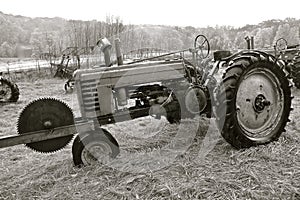 Old John Deere tractor with a huge saw blade