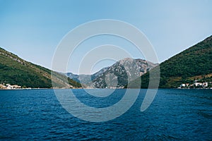 Verige Strait in Kotor Bay, Montenegro, against the backdrop of the city of Perast. photo
