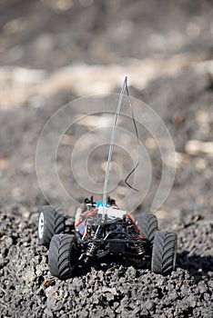 Veritcal of toy RC truck on dirt mound, no body photo