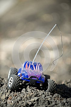 Veritcal of toy RC truck on dirt mound photo