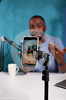 Veritical selective focus on live video podcast setup recording content creator moving hands