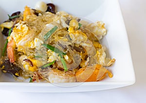 Vermicelli fried with vegetable, egg and shrimp on dish