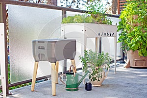 A vermicomposting system worm composter sits on an apartment balcony