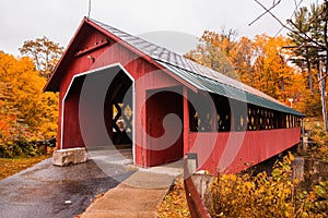 Vermont covered bridge surrounded by colorful fall foliage.