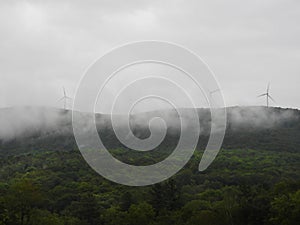 Vermont windtower farm shrouded in morning fog photo