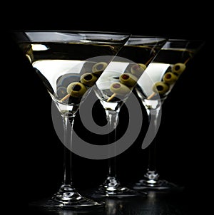 Vermouth Martini drinks with olives isolated on black