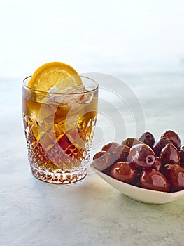 A vermouth served with a olives tapa
