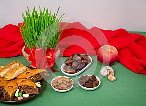 The vernal equinox, a traditional table on Navruz. wheat grass, Arabic baklava dessert, sweets, nuts, dried fruits