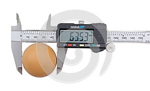 Vernier caliper and egg isolated on white