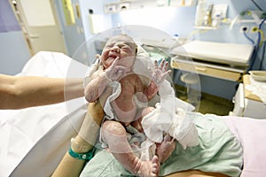 Vernix covered newborn after delivery