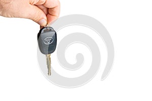 A dangling car key isolated on a white background.