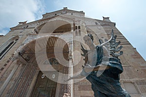 Verona Cathedral exterior and a bronze angel inviting visitors