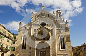 Verona Cathedral facade over blue sky with white clouds