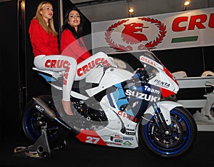 Verona, Italy - january 20, 2018: motor bike expo, two young hostess posing on motorbike. Verona, Veneto, Italy