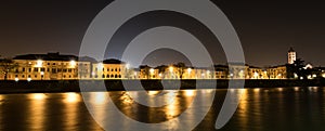 Verona at night with the Adige river - Italy