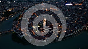 Verona skyline, aerial view of historical city centre at night evening, Italy