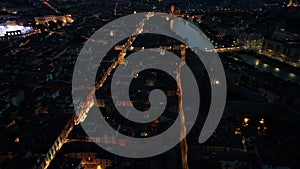 Verona skyline, aerial view of historical city centre at night evening, Italy