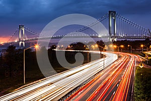 Verrazano Narrows Bridge above the light trails of the Belt Parkway traffic.