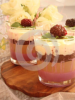 Verrine with chocolate, creamy mousse, berry confit and almond b