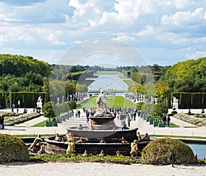 Versailles Castle gardens with fountain & tourists