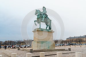 Versailles, France - 10.01.2019: Equestrian statue of Louis XIV on Place d`Armes in front of Palace of Versailles. Palace