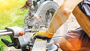 Versatile craftsman working with wood to build a house on a summer day, DIY concept photo