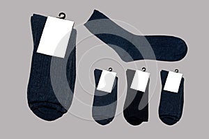 Versatile, new, warm socks on grey background.