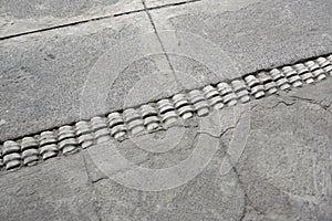 Vertebrae bones inlaid into a concrete patio, Palacio Arzobispal, Plaza de la Independencia, Quito, EC