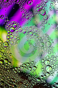 Vertical abstract background of green and pink bubbles