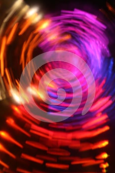 Vertical abstract background with staggered and refracted vortex light effects