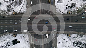 Vertical Aerial drone view of road junction, large car interchange. Aerial highway junction at winter evening