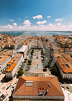 Vertical aerial drone view of Rossio Square and Baixa District in Lisbon, Portugal with major landmarks visible