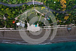 Vertical aerial photo of a beach, a beautiful park road. Photo f