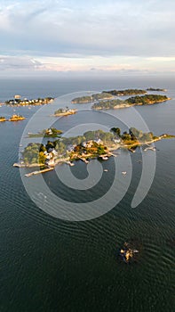 Vertical aerial shot of Thimble Islands in Branford with a beautiful waterscape and a skyline