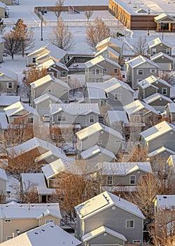 Vertical Aerial view of building and houses against a white landscape of fresh snow