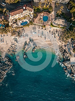 Vertical aerial view of Conchas Chinas Beach in PV Mexico showing clear turquoise water in ocean photo