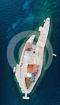 Vertical aerial view of the island of the Church of Our Lady of the rocks in Kotor Bay, Montenegro