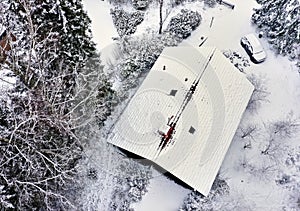 Vertical Aerial View of a Snow-Covered Single-Family House Roof