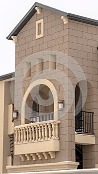 Vertical Apartment with snowy front gable roof and balustrade on the arched balcony